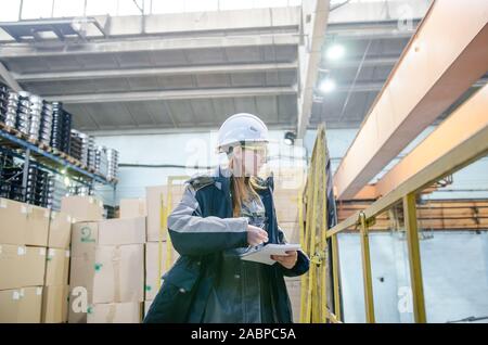 Young female engineer of large industrial plant. Industrial zone Stock Photo