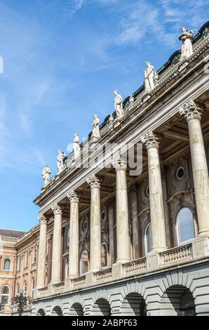 Budapest, Hungary - Nov 6, 2019: Buildings in the complex of Buda Castle. The historical palace building, facade with pillars and arch windows. Tourist attraction and national heritage. Stock Photo