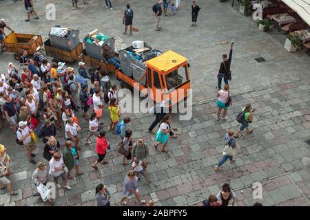 Montenegro, Sep 22, 2019: A large group of tourists follow the guide at the Saint Tryphon Plaza in Kotor Old Town Stock Photo