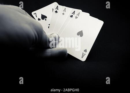 Poker playing cards held in hands with aces Stock Photo