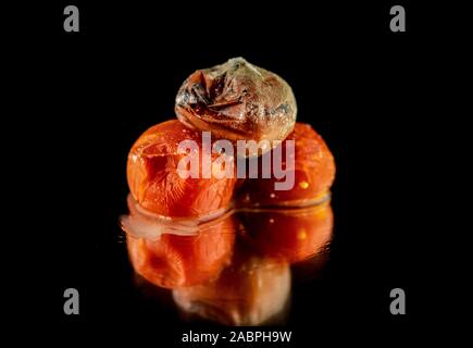 Rotten Fruit With Slight Decay On A Reflective Surface Stock Photo Alamy