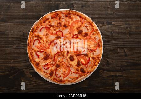 ham and vegetables pizza dish over dark wooden background Stock Photo