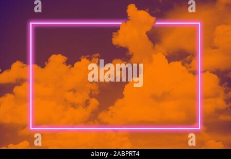 Vibrant sky with clouds layout and pink neon glowing frame. Vapor wave retro pattern for design. Ultra violet colors. Stock Photo