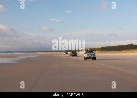 4WD vehicles on Eurong Beach, part of Seventy-Five Mile Beach. Great Sandy National Park, Fraser Island, Queensland, Australia