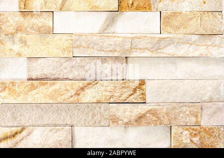 Close-up of Natural River Stone Cladding Mosaic Tile Wall .Old stone facade, seamless pattern . Top view, copy space. Stock Photo