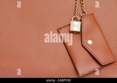 Brown women leather wallet hanging on handbag . Fashion accessory . Stock Photo