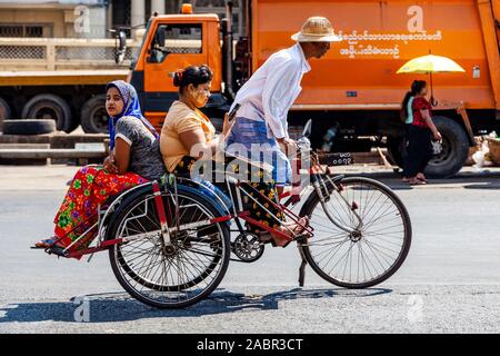 A Bicycle Taxi Carrying Passengers, Yangon, Myanmar. Stock Photo