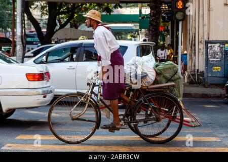 A Bicycle Taxi Driver Transporting Goods, Yangon, Myanmar. Stock Photo
