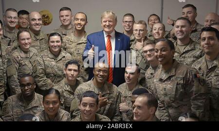 Bagram, Afghanistan. 28 November, 2019. U.S. President Donald Trump poses with service members during a surprise Thanksgiving Day visit to Bagram Air Field  November 28, 2019 in Bagram, Afghanistan. Trump’s visit was his first to Afghanistan since becoming president.   Credit: White House Photo/Planetpix/Alamy Live News Stock Photo