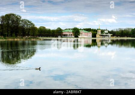 Moscow, RUSSIA-May 11, 2015: Kuskovo park, pond and Kuskovo palace. Kuskovo was the estate of the Sheremetev family in spring Stock Photo