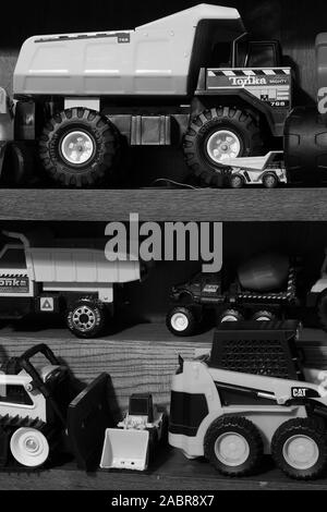 Toy construction vehicles stored on a shelf Stock Photo