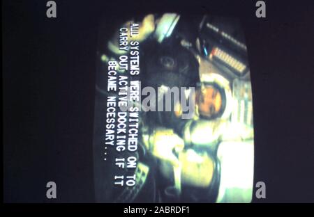 Teleclip - Apollo-Soyuz Test Project - 'All systems were switched on to carry out active docking if it became necessary...' subtitle; - Alexei Leonov - Valeri Kubasov inside Soyuz 19 capsule moments before docking with Apollo CSM-111 - photo taken directly from color TV screen in the UK - by 'Harry' (the unknown photographer) during the live broadcasts in July 1975. The Apollo–Soyuz Test Project (ASTP) (Russian: Экспериментальный полёт «Аполлон» – «Союз» (ЭПАС), Eksperimentalniy polyot Apollon-Soyuz. 'Experimental flight Apollo-Soyuz', commonly referred to by the Soviets as Soyuz–Apollo), Stock Photo