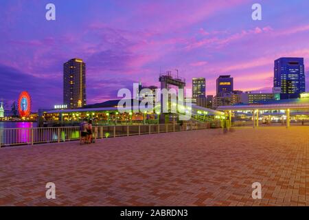 Kobe, Japan - October 11, 2019: Sunset view of the Port, with the Children Museum, other landmarks, locals and visitors, in Kobe, Japan Stock Photo