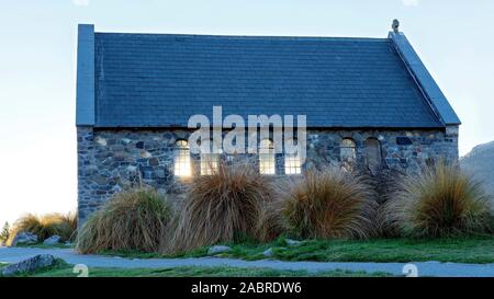 Late afternoon sunlight shines through the windows of the famous Church Of The Good Shepherd on Lake Tekapo in New Zealand Stock Photo