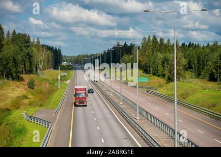 VALDAY, RUSSIA - AUGUST 10,2019: Automobile traffic on the highway M-11 Moscow - St. Petersburg on a summer day. Highway section in the area of Valdai Stock Photo