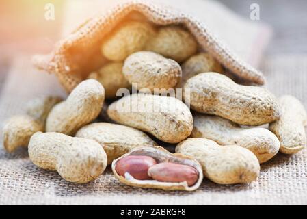 Peanut in shells for food or snack / Roasted peanuts on sack background Stock Photo