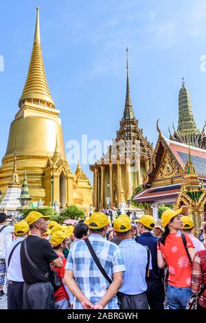 Bangkok, Thailand - November 17, 2019: Tourists at the Grand Palace a famous tourist destination with the Temple of the Emerald Buddha.