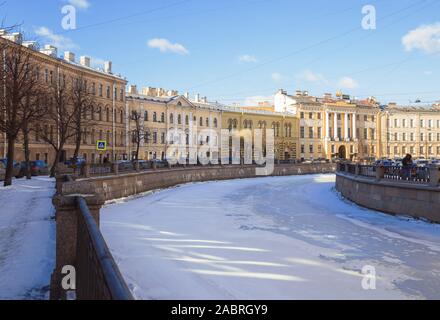 Old mansions and apartment houses of the mid-19th century on the embankment of the Griboyedov canal. Sunny winter day in St. Petersburg, Russia Stock Photo