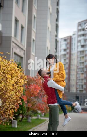 Moments of happiness. Nice happy woman looking at her beloved man while being held by him Stock Photo