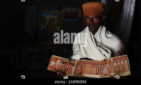 Lalibala/Ethiopia Ethiopian Christian monk in Asheton Maryam Monastery in Amhara Region, Ethiopia,  shows ancient art held at the monastery Stock Photo