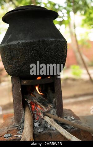 Heating a large pot of water in rural India Stock Photo