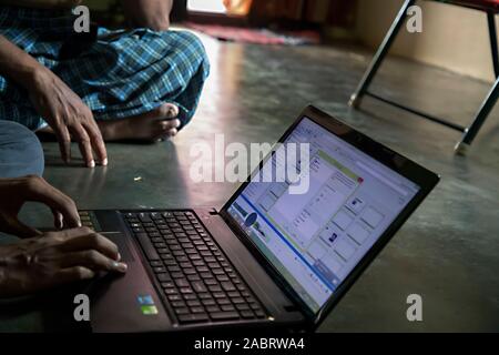 Indian village people operating laptop Stock Photo