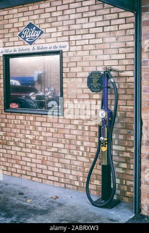 Vintage BP petrol pump in a workshop at Bicester Heritage Centre autumn Sunday Scramble event. Bicester, Oxfordshire, England. Vintage filter applied Stock Photo
