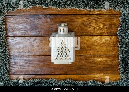 Christmas composition on wooden board with Christmas garland and decorations. Creative composition with border and copy space, top view, flat lay. Chr Stock Photo