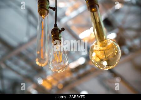 Beautiful retro luxury light lamp decor glowing. classic different retro light bulbs hanging on brick wall background at night . Decorative antique Stock Photo