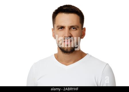 Portrait of young frowned handsome bearded man on white background. facial expression Stock Photo
