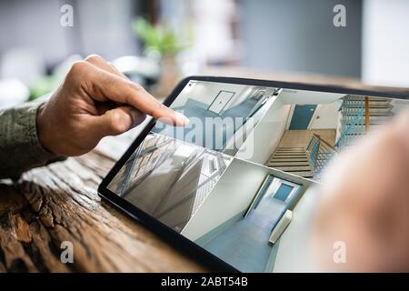 Person Monitoring Cameras Live View Of Home On The Digital Tablet Stock Photo