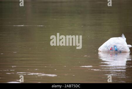 Plastic back floating on the Dokhtawady River in Myanmar. Stock Photo