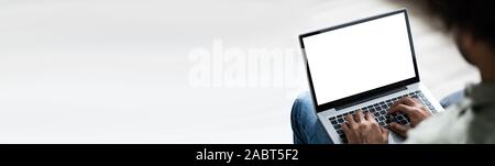 Close-up Of Young Man Working On Laptop At Home Stock Photo