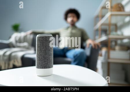 Young Man Using Wireless Speaker At Home Stock Photo