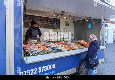 Fishmonger's van stall with a display of fresh fish in Staines-Upon-Thames Market, High Street, Staines, a town in Spelthorne, Surrey, SE England, UK Stock Photo