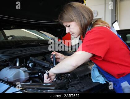 woman repairing car in Garage Stock Photo