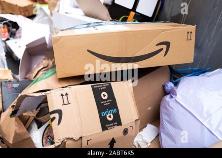 Valencia, Spain - November 29, 2019: Amazon Prime cardboard box thrown in the trash in a pile of rubbish on the street after Black Friday Stock Photo