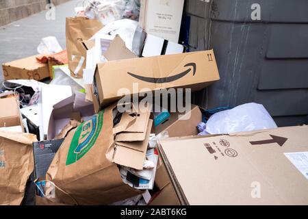 Valencia, Spain - November 29, 2019: Amazon Prime cardboard box thrown into a pile of trash from a full dumpster. Stock Photo