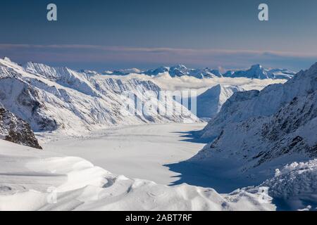 Aerial of snowcapped mountain range of Jungfrau in winter before sunset, view from Jungfraujoch in middle of Jungfrau and Monch, Interlaken, Switzerla Stock Photo