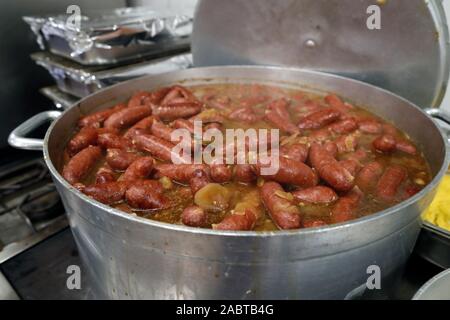 Cooking diots in a kitchen. A diot is a sausage from the French region of Savoy.  Domancy. Stock Photo