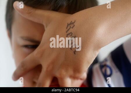 Teenagers with a rebel tatoo in Montrouge, France. Stock Photo