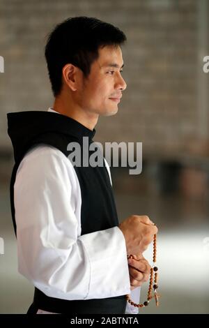 Cistercian Abbey.  Our Lady of My Ca. Monk praying the Rosary. Vietnam. Stock Photo