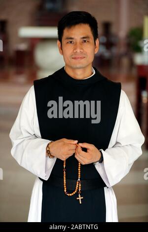 Cistercian Abbey.  Our Lady of My Ca. Monk praying the Rosary.  Vietnam. Stock Photo