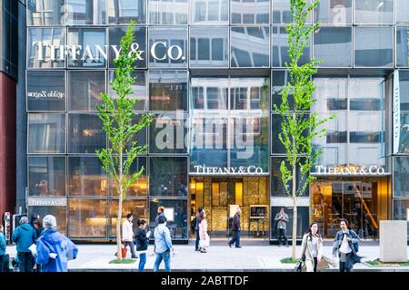 The exterior of the Tiffany Ginza building with people walking by on a springtime weekend when the street becomes a pedestrian precinct. Daytime. Stock Photo