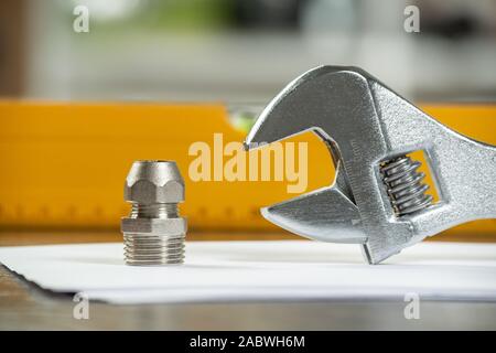 Plumbing pipeline element and adjustable wrench Stock Photo