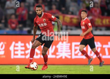 Brazilian-born Portuguese football player Dyego Sousa of Shenzhen F.C., left, keeps the ball during the 29th round match of Chinese Football Association Super League (CSL) against Henan Jianye in Shenzhen city, south China's Guangdong province, 27 November 2019. Shenzhen F.C. tied the game with Henan Jianye with 3-3. Stock Photo