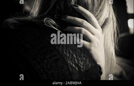 A worried woman from the back in black and white Stock Photo