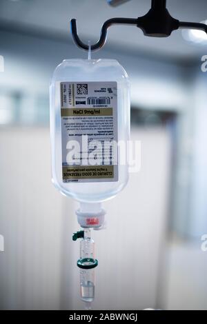 Saline Solution IV Drip Fluid for Infusion in Hospital Background. Intravenous infusion drip equipment in hospital Stock Photo