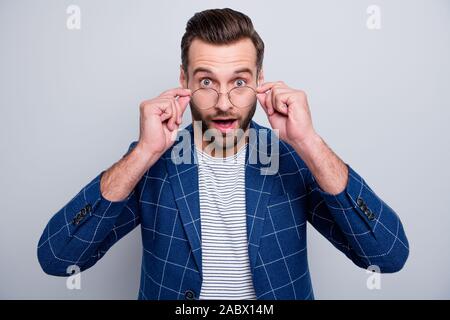 Photo of excited smart man looking at you wearing specs observing his eye sight normalizing after buying new eye glasses discounted isolated grey Stock Photo
