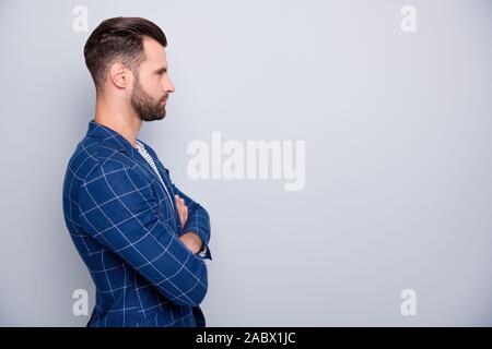 Profile side view portrait of his he nice serious attractive bearded guy wearing checked blazer folded arms modern cool haircut folded arms isolated Stock Photo
